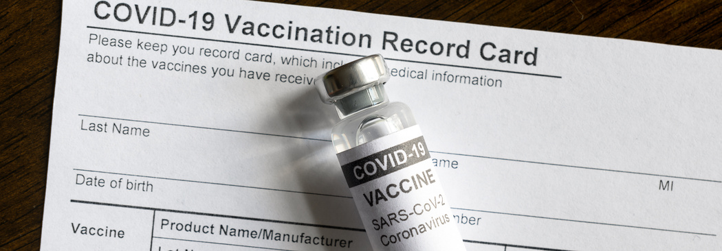 COVID-19 vaccine bottle on coronavirus Vaccination Record Card